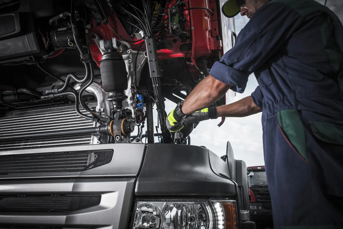 Technician working in a truck engine bay