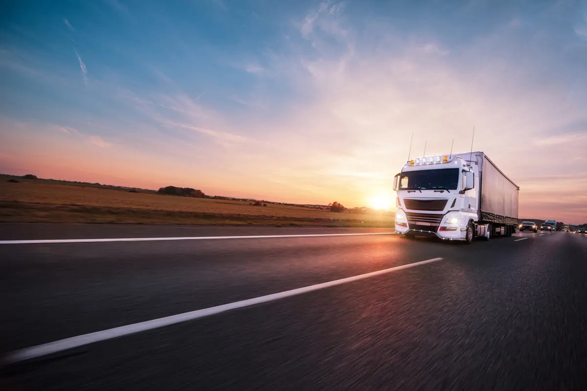 Truck on the highway at sunset