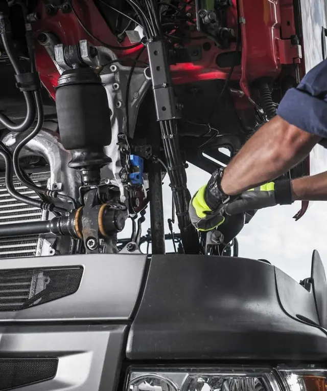 Technician working on truck air suspension