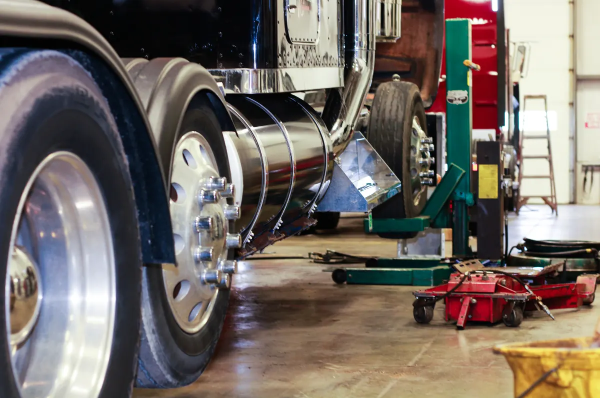 Heavy-duty truck lifted in a workshop